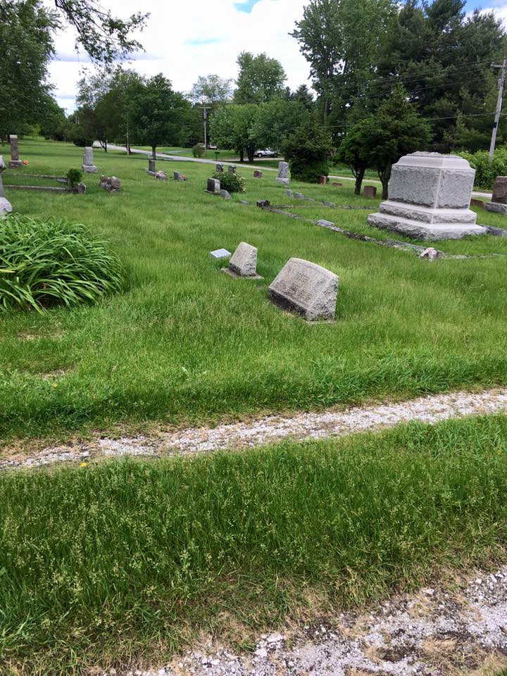 Green cemetery grounds with monuments and lush grass